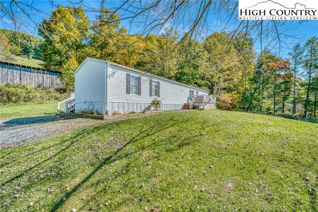 1310 Meat Camp Road Boone, NC 28607 - Photo 11 of 32 a house with green field