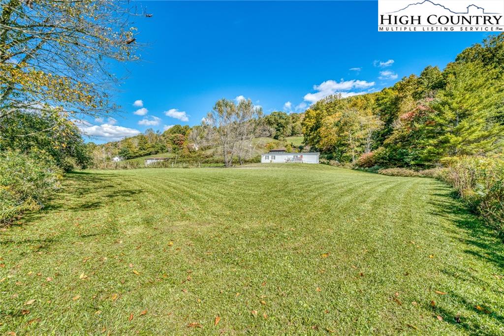 1310 Meat Camp Road Boone, NC 28607 - Photo 17 of 32 a view of a big yard with swimming pool and green space