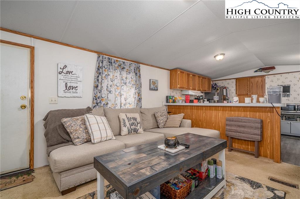 1310 Meat Camp Road Boone, NC 28607 - Photo 19 of 32 a living room with furniture and a kitchen view