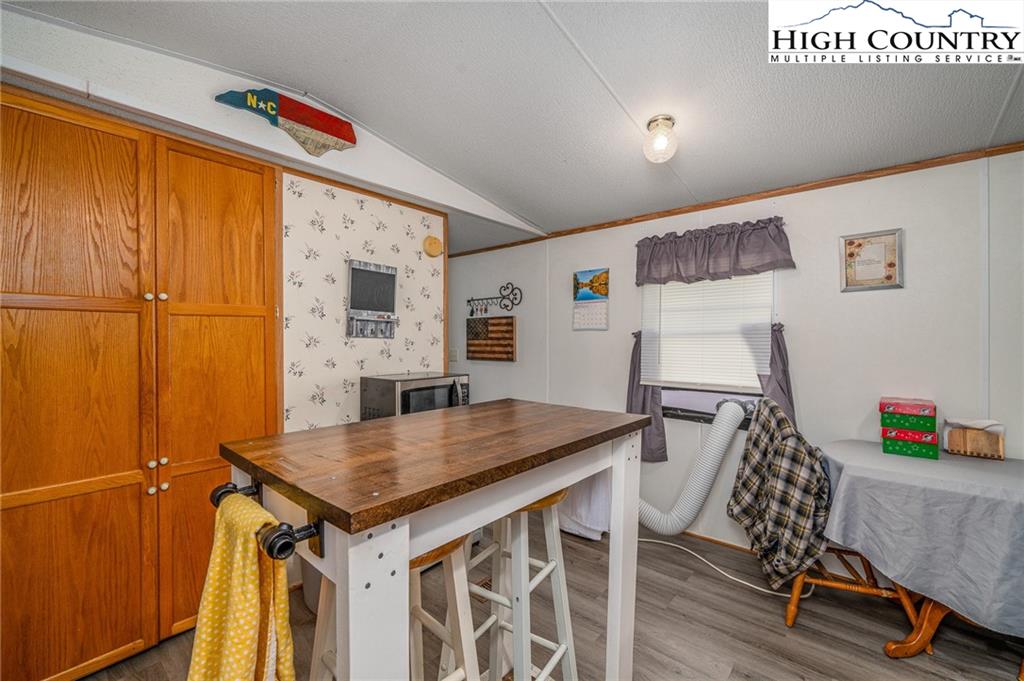 1310 Meat Camp Road Boone, NC 28607 - Photo 23 of 32 a view of kitchen island with furniture and wooden floor