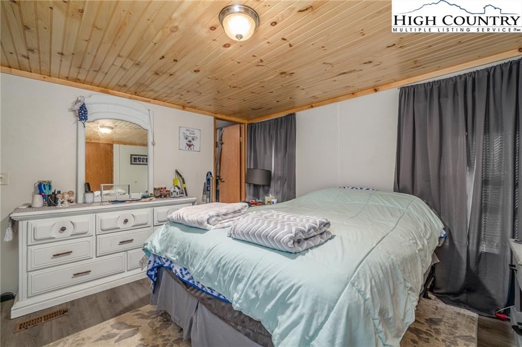 1310 Meat Camp Road Boone, NC 28607 - Photo 24 of 32 a bedroom with a large bed and a dresser