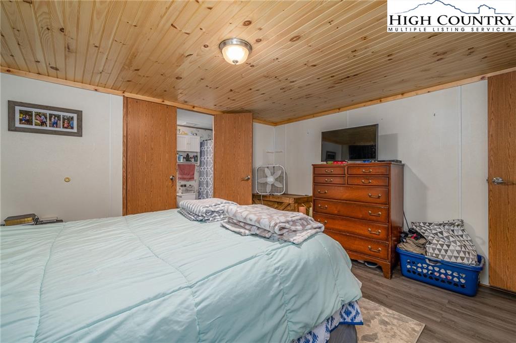 1310 Meat Camp Road Boone, NC 28607 - Photo 25 of 32 a bedroom with a bed and a flat screen tv
