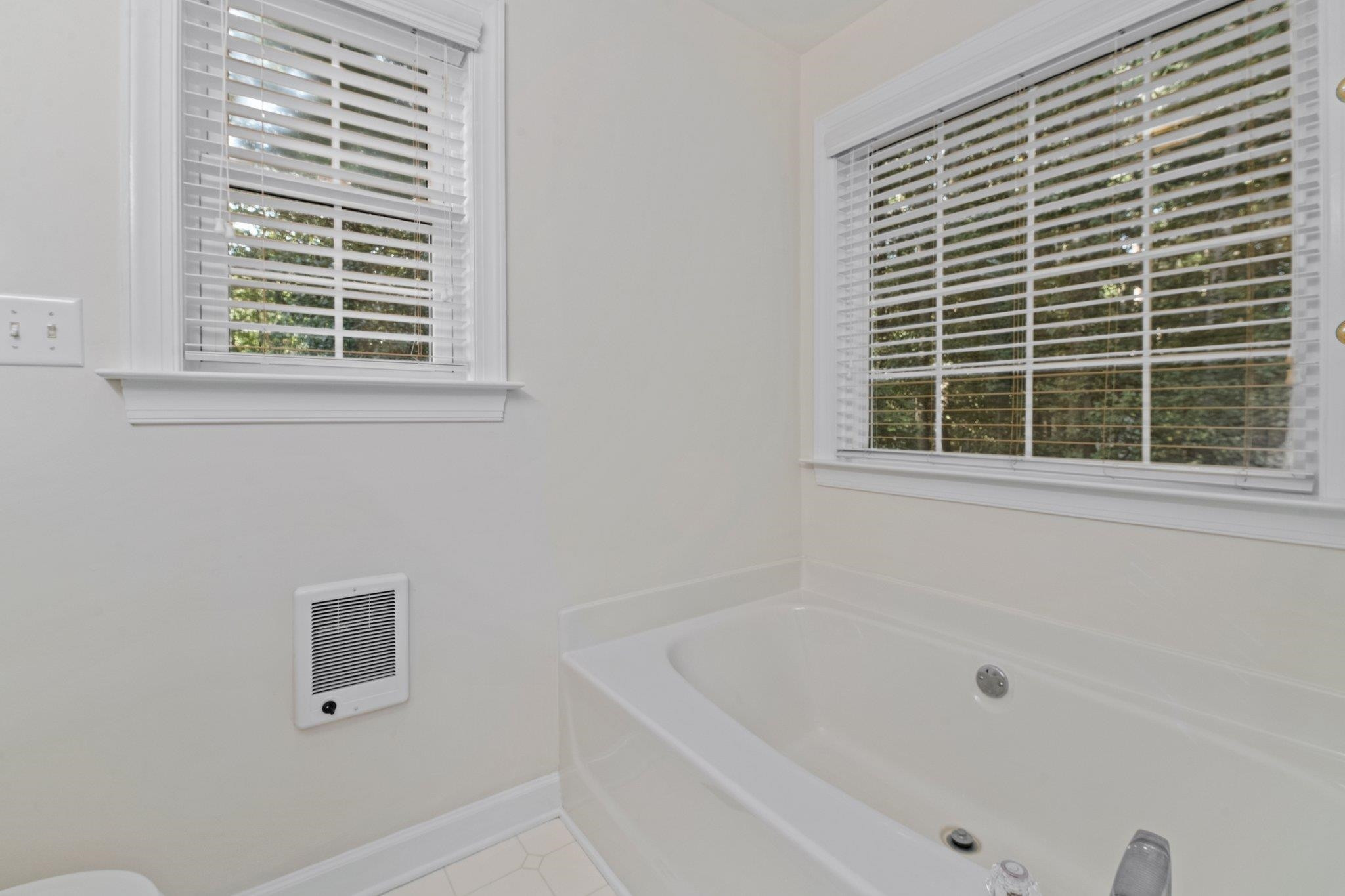 8025 Lockleair Road Zebulon, NC 27597 - Photo 27 of 30 Soaking tub with lots of windows for natural light. Separate shower with glass door. Double vanity. Master Bedroom