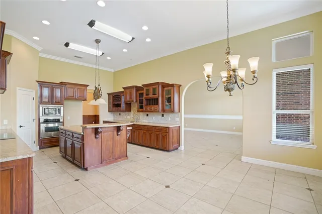 a kitchen with granite countertop a sink and a stove