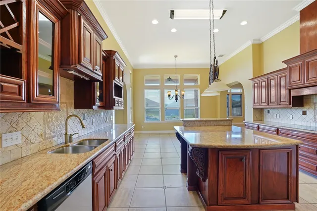 a kitchen with stainless steel appliances granite countertop a sink and a cabinets