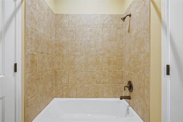 a spacious bedroom with a bed and large windows