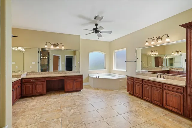 a view of a bathroom with sink mirror and bathtub