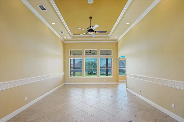 a view of an empty room with a fireplace and a window
