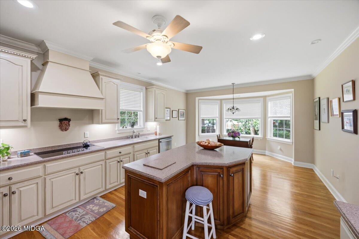 210 Oberon Place Macon, GA 31210 - Photo 12 of 31 a kitchen with a stove a sink a dining table and chairs