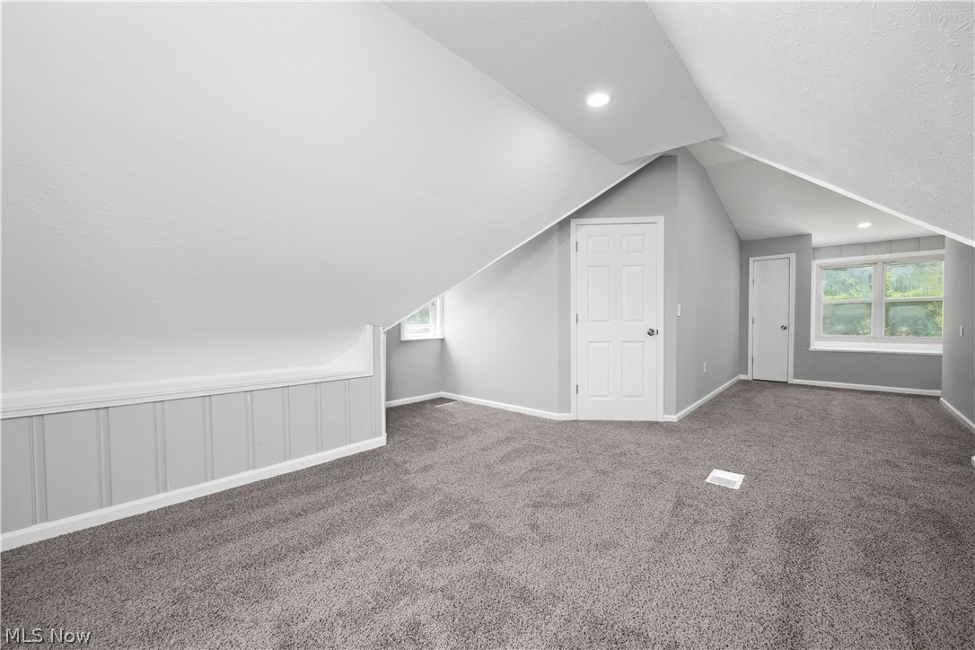 7030 Pearl Road Cleveland, OH 44130 - Photo 29 of 34 Bonus room with vaulted ceiling and dark colored carpet