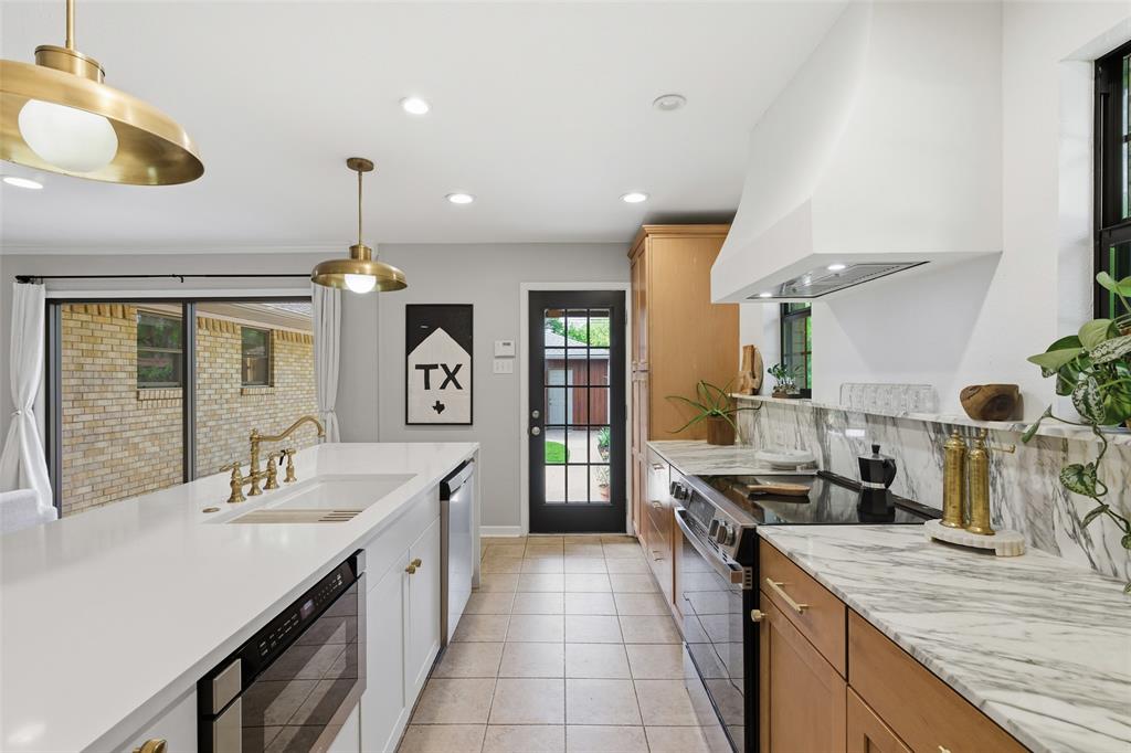 717 Ridgedale Drive Richardson, TX 75080 - Photo 13 of 40 Lovely pendant lighting adorns the breakfast bar.