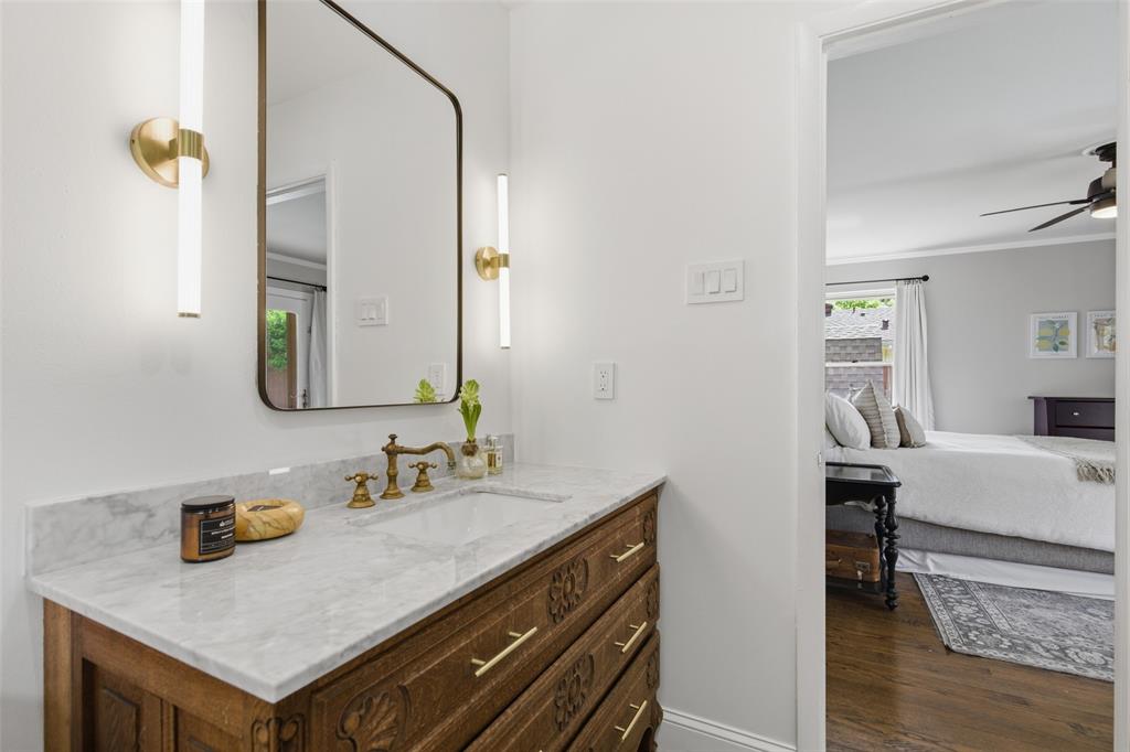 717 Ridgedale Drive Richardson, TX 75080 - Photo 27 of 40 Completely renovated ensuite primary bathroom has an antiqued vanity