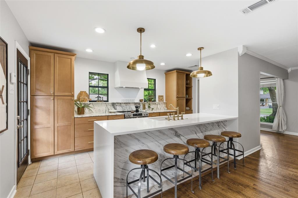 717 Ridgedale Drive Richardson, TX 75080 - Photo 3 of 40 Chef's kiss for this renovated kitchen with beautiful cabinetry and a breakfast bar.