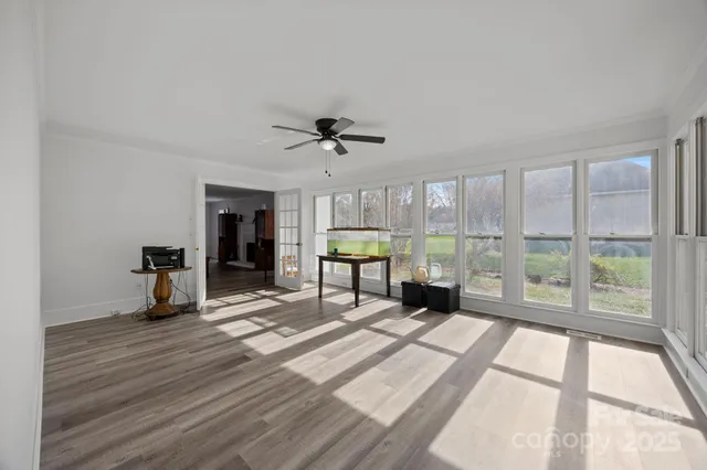 a view of a livingroom with furniture and a garden