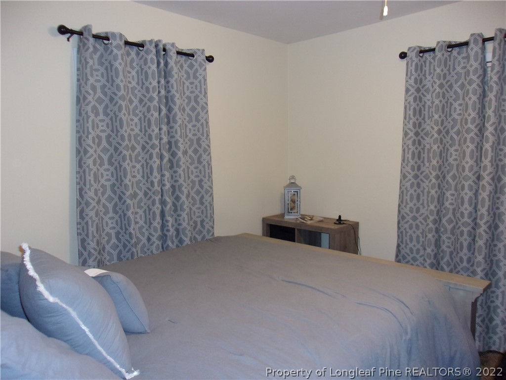 170 Wade-Stedman Road Stedman, NC 28391 - Photo 2 of 12 a bedroom with a bed and a couch
