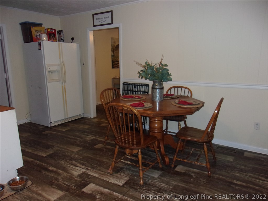 170 Wade-Stedman Road Stedman, NC 28391 - Photo 8 of 12 a view of a dining room with furniture and wooden floor