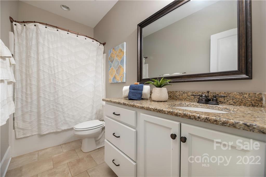 240 Patternote Road Mooresville, NC 28117 - Photo 31 of 47 a bathroom with a granite countertop sink mirror vanity and toilet