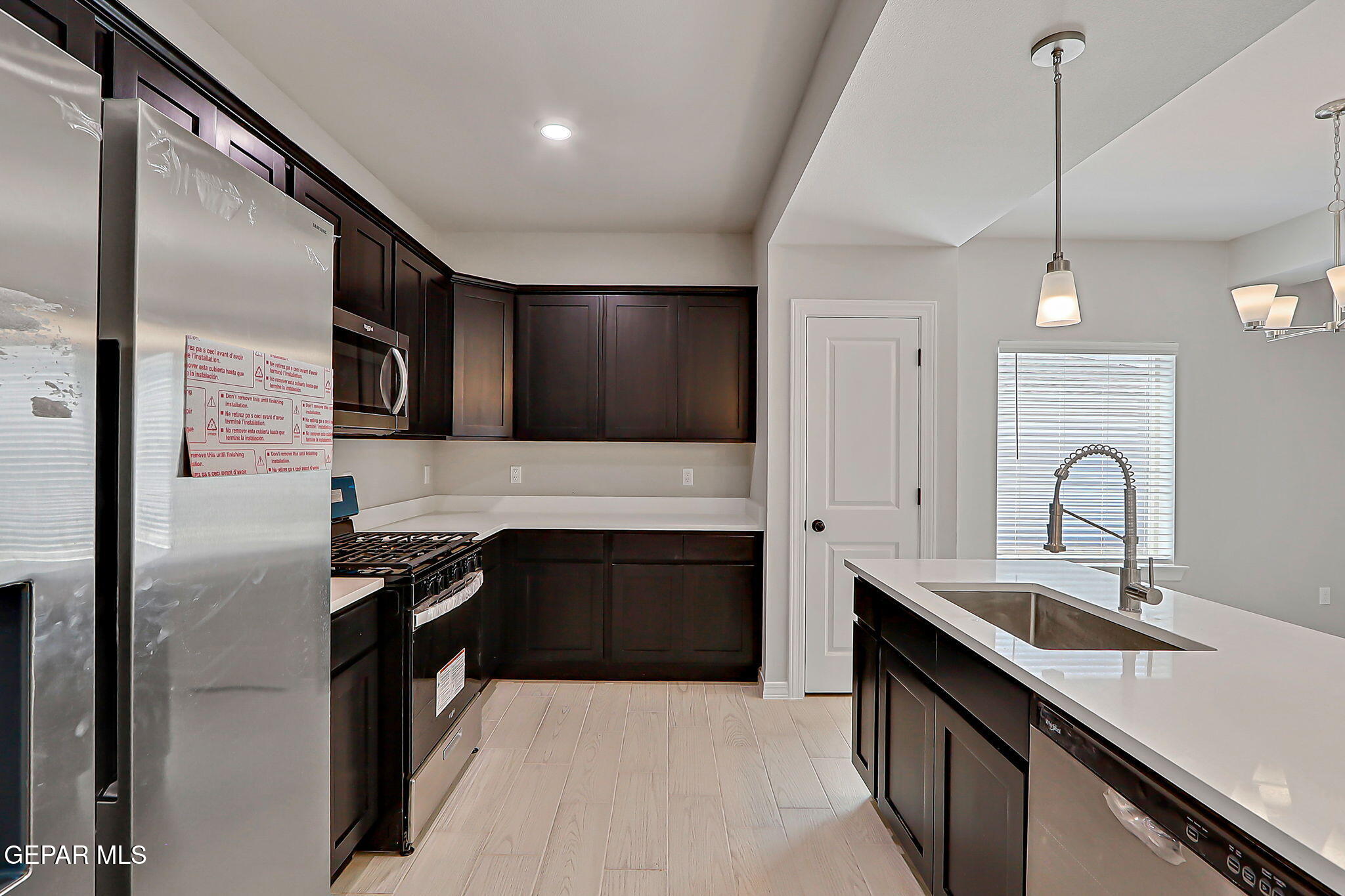 3949 Perspective Street El Paso, TX 79938 - Photo 10 of 22 a kitchen with stainless steel appliances granite countertop a sink stove and refrigerator