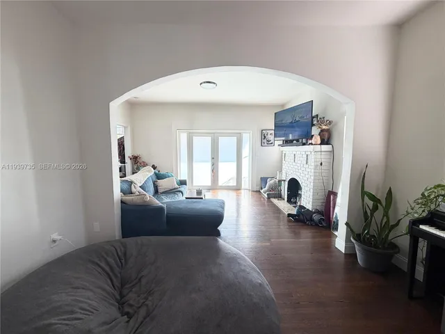 a living room with furniture a fireplace and a potted plant