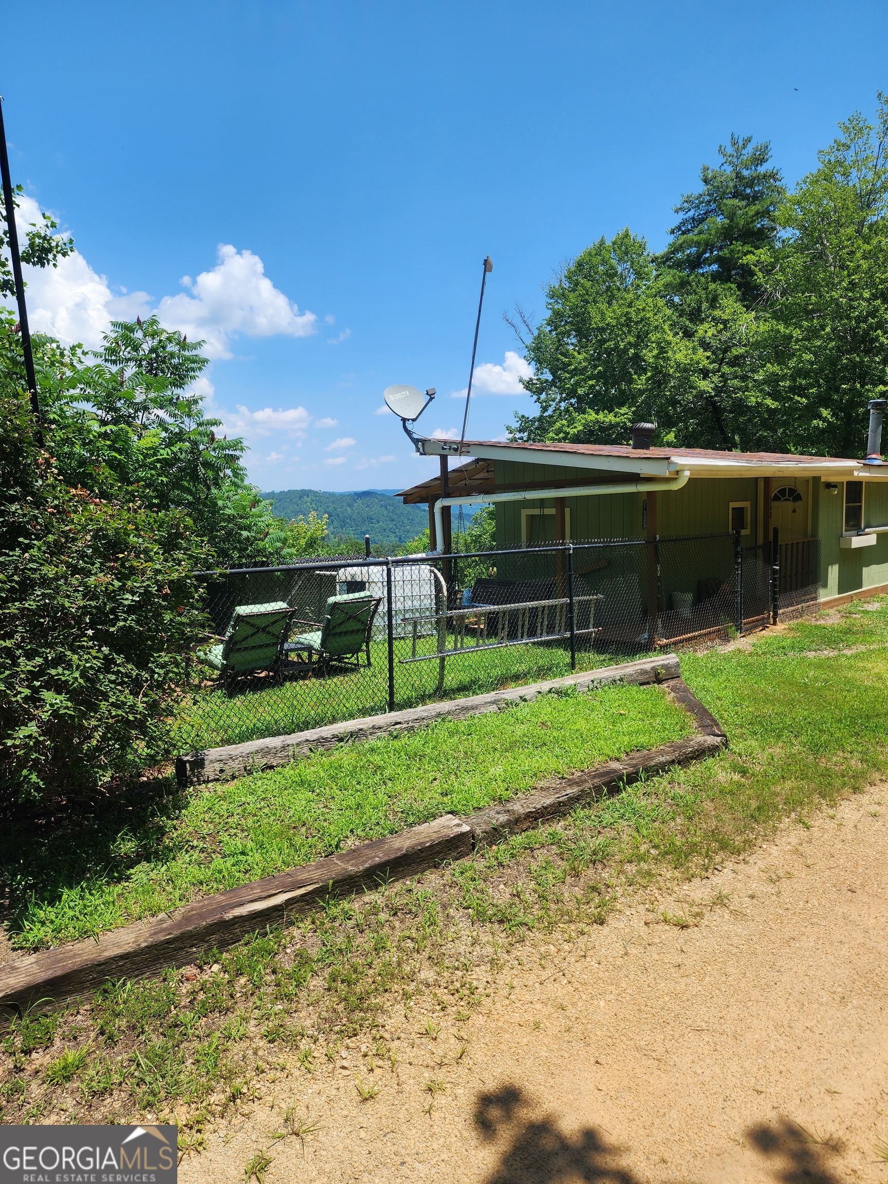 568 Yonah Lake Road Toccoa, GA 30577 - Photo 4 of 21 a view of a house with backyard and a garden