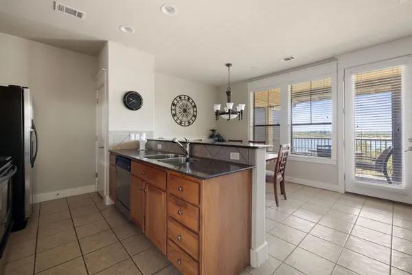 a kitchen with a stove a refrigerator and a cabinets