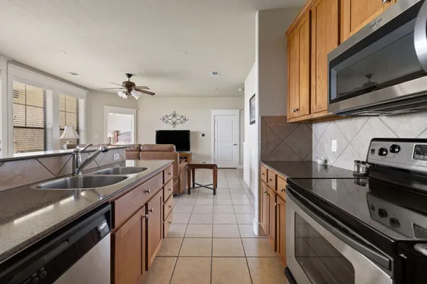 a kitchen with a sink appliances and cabinets