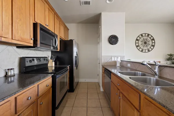 a kitchen with a sink and a refrigerator