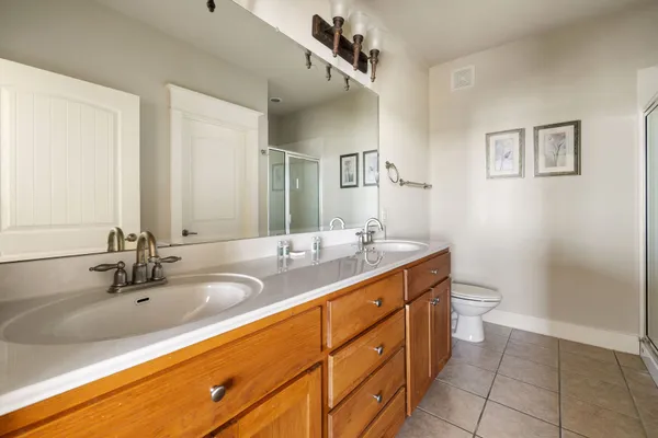 a bathroom with a double vanity sink and a mirror