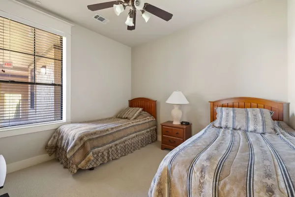 a bedroom with two beds and a window
