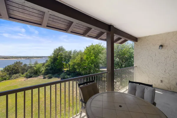 a view of a two chairs in the balcony