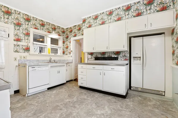 a kitchen with cabinets oven and a dishwasher