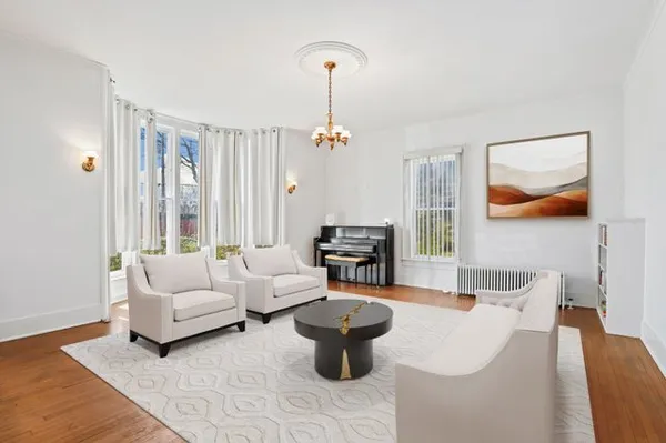 a living room with furniture and a chandelier