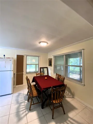a dining room with furniture and window