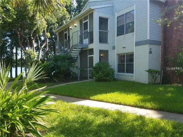 a view of a house with a yard and plants