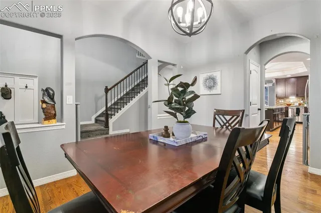 a view of a dining room with furniture and a chandelier