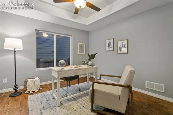 a work room with furniture and wooden floor