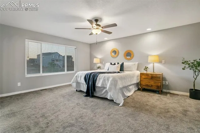 a bedroom with a large bed and a window