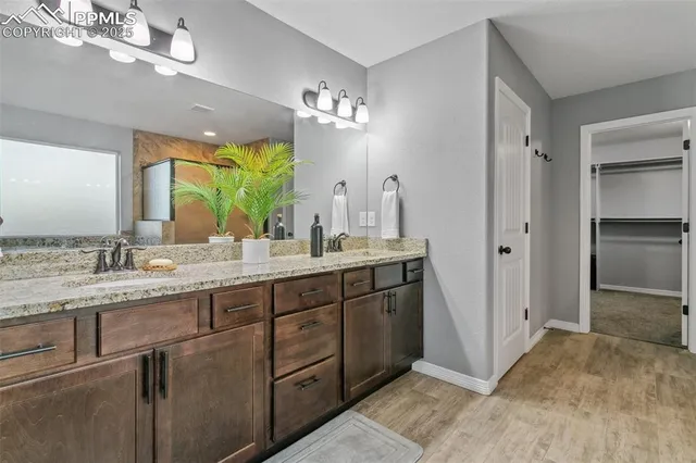 a bathroom with a double vanity sink and a mirror