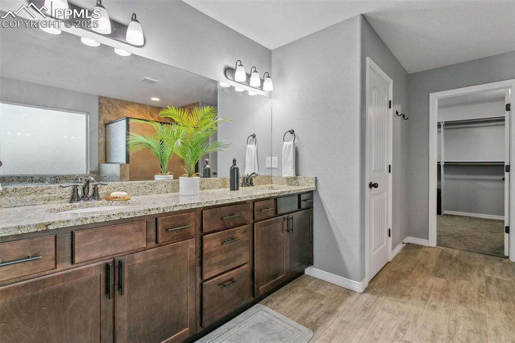9632 Emerald Vista Drive Peyton, CO 80831 - Photo 23 of 45 a bathroom with a double vanity sink and a mirror