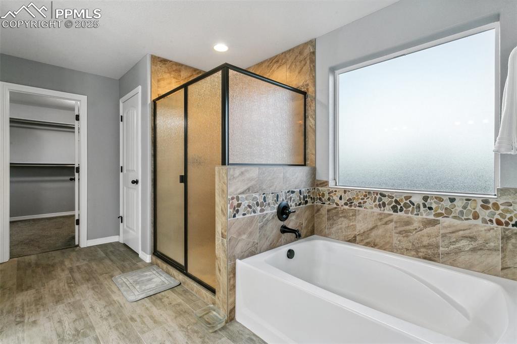 9632 Emerald Vista Drive Peyton, CO 80831 - Photo 24 of 45 a bathroom with a bathtub and a shower