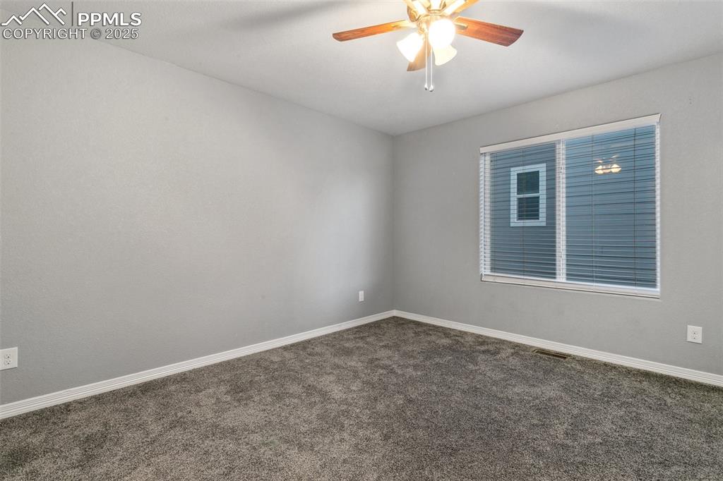 9632 Emerald Vista Drive Peyton, CO 80831 - Photo 26 of 45 an empty room with a chandelier fan
