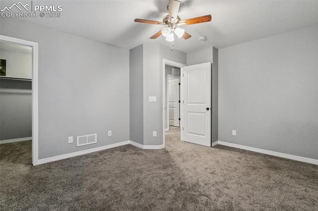 9632 Emerald Vista Drive Peyton, CO 80831 - Photo 27 of 45 an empty room with closet and a ceiling fan