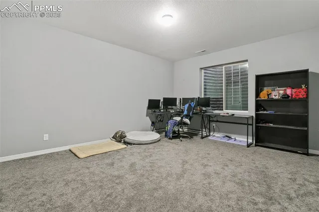 an empty room with furniture and a flat screen tv
