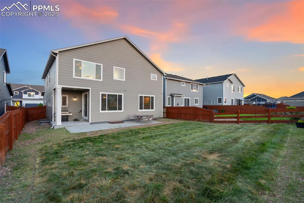 9632 Emerald Vista Drive Peyton, CO 80831 - Photo 37 of 45 a view of a yard in front of a house with large windows