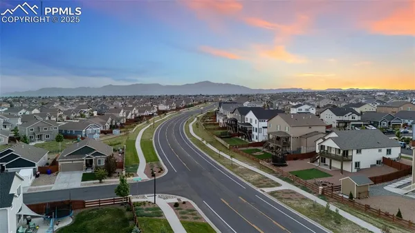 an aerial view of residential houses with outdoor space