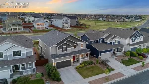 an aerial view of a house with a big yard