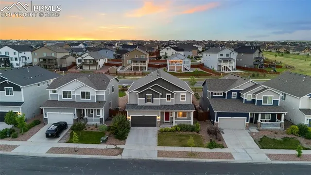 an aerial view of residential houses with street view