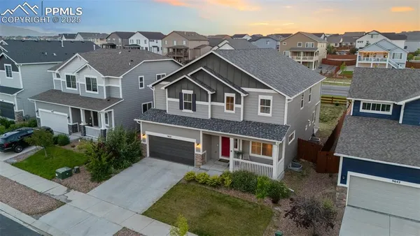 an aerial view of a house with a yard