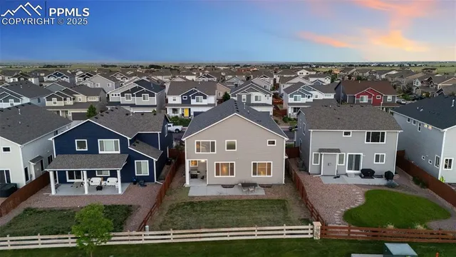 an aerial view of a house with a yard