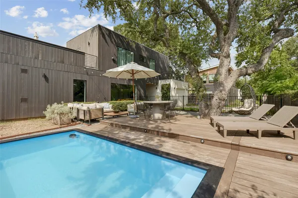 swimming pool view with a seating space